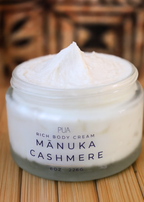 Jar of Manuka Cashmere body cream on a wooden surface